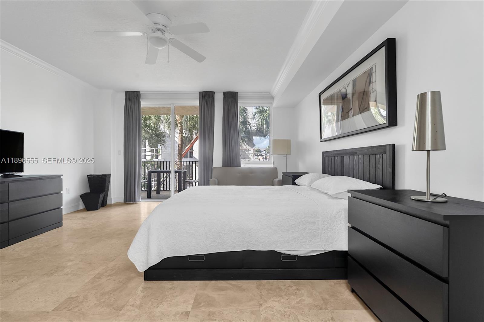 9 Northeast 20th Avenue, Unit 302 Deerfield Beach, FL 33441 - Photo 22 of 55 a bedroom with a large bed a flat tv screen and dresser