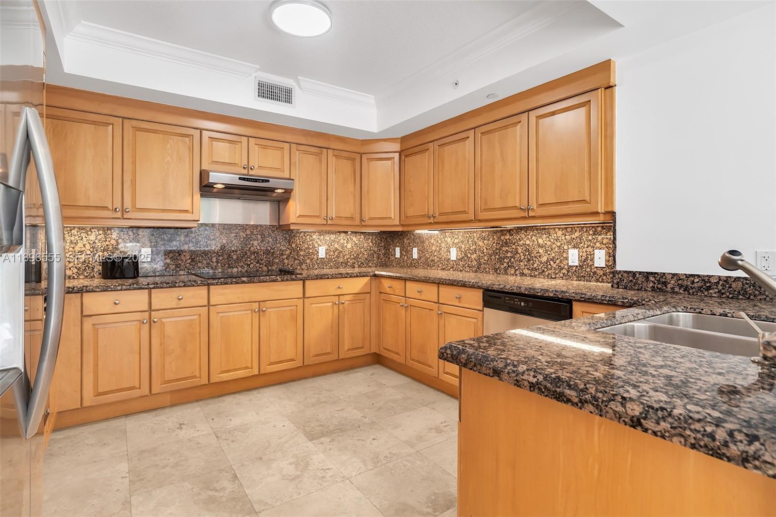9 Northeast 20th Avenue, Unit 302 Deerfield Beach, FL 33441 - Photo 28 of 55 a kitchen with stainless steel appliances granite countertop a sink a stove and cabinets