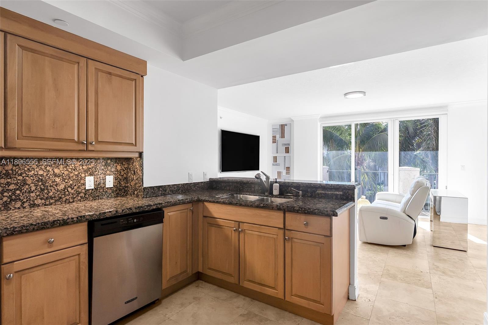 9 Northeast 20th Avenue, Unit 302 Deerfield Beach, FL 33441 - Photo 32 of 55 a kitchen with granite countertop cabinets a sink and a stove