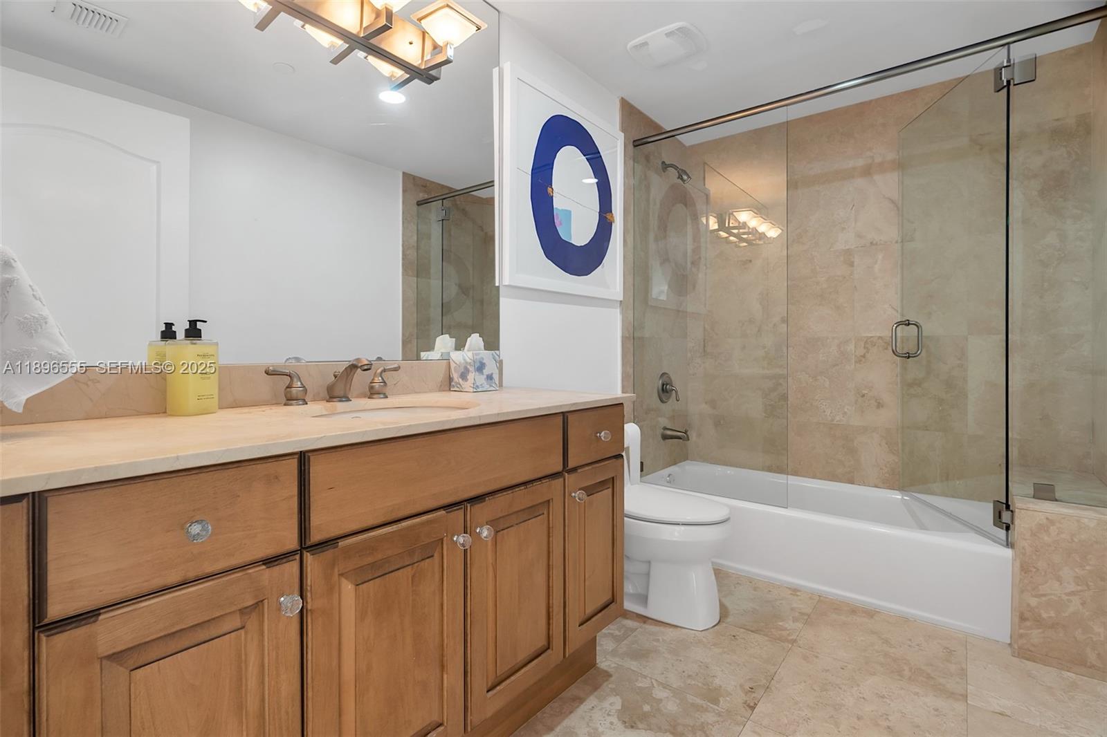 9 Northeast 20th Avenue, Unit 302 Deerfield Beach, FL 33441 - Photo 38 of 55 a bathroom with a toilet a sink and a shower