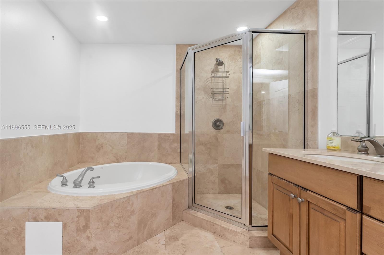 9 Northeast 20th Avenue, Unit 302 Deerfield Beach, FL 33441 - Photo 42 of 55 a bathroom with a tub sink and mirror