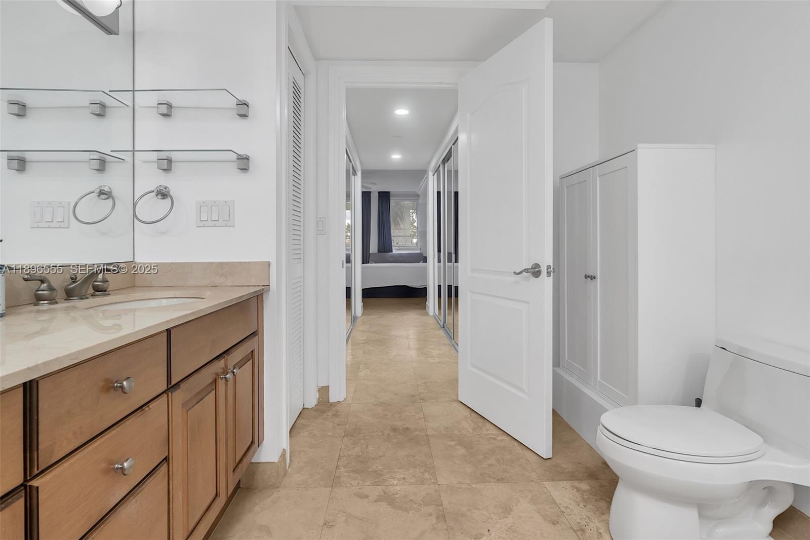 9 Northeast 20th Avenue, Unit 302 Deerfield Beach, FL 33441 - Photo 43 of 55 a bathroom with a granite countertop sink toilet and shower