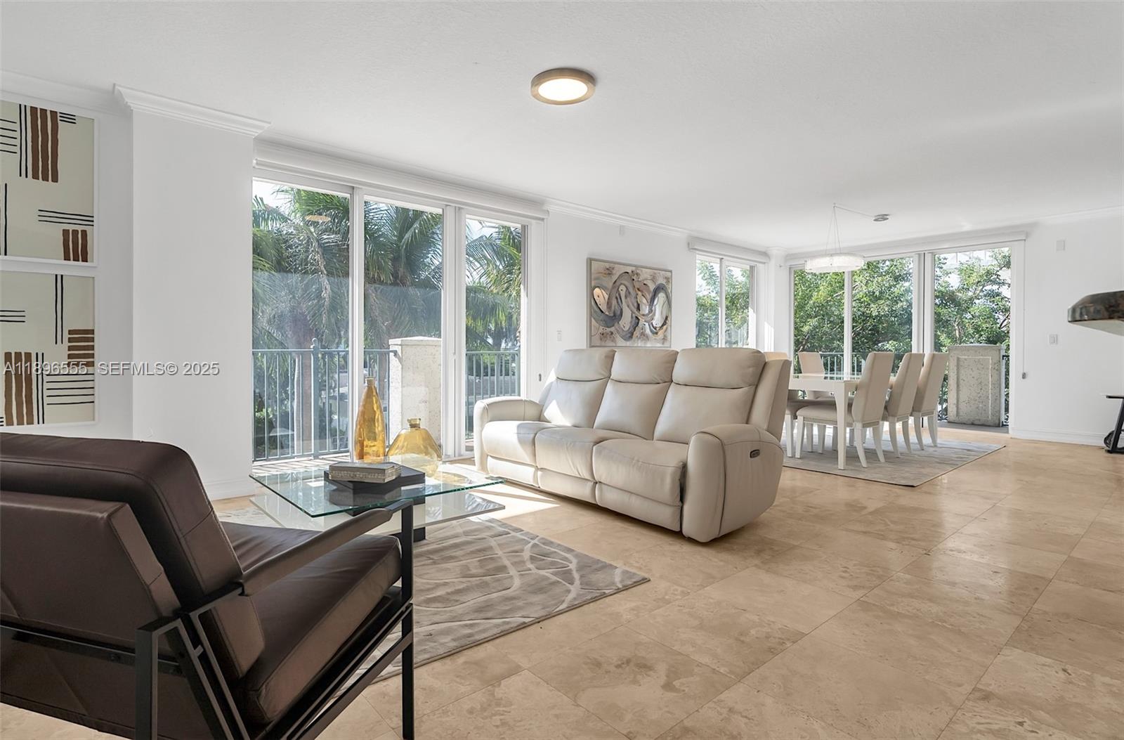 9 Northeast 20th Avenue, Unit 302 Deerfield Beach, FL 33441 - Photo 8 of 55 a living room with furniture and a large window