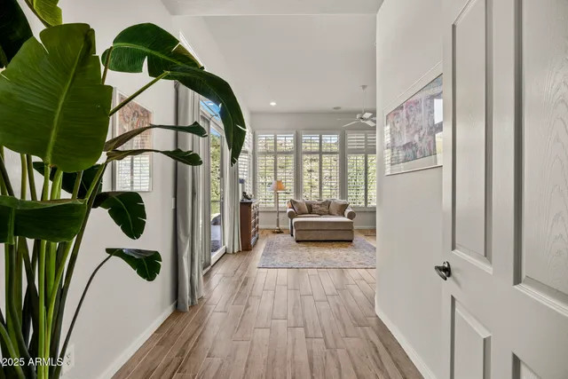 a view of entryway and hall with wooden floor