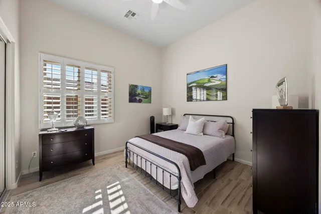 a bedroom with a bed and a window