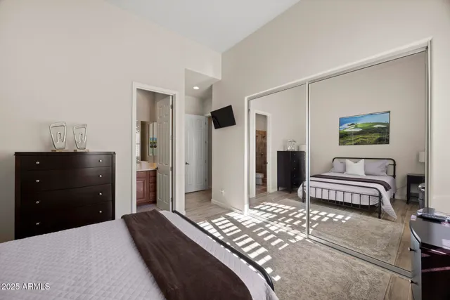 a bedroom with a bed and a dresser