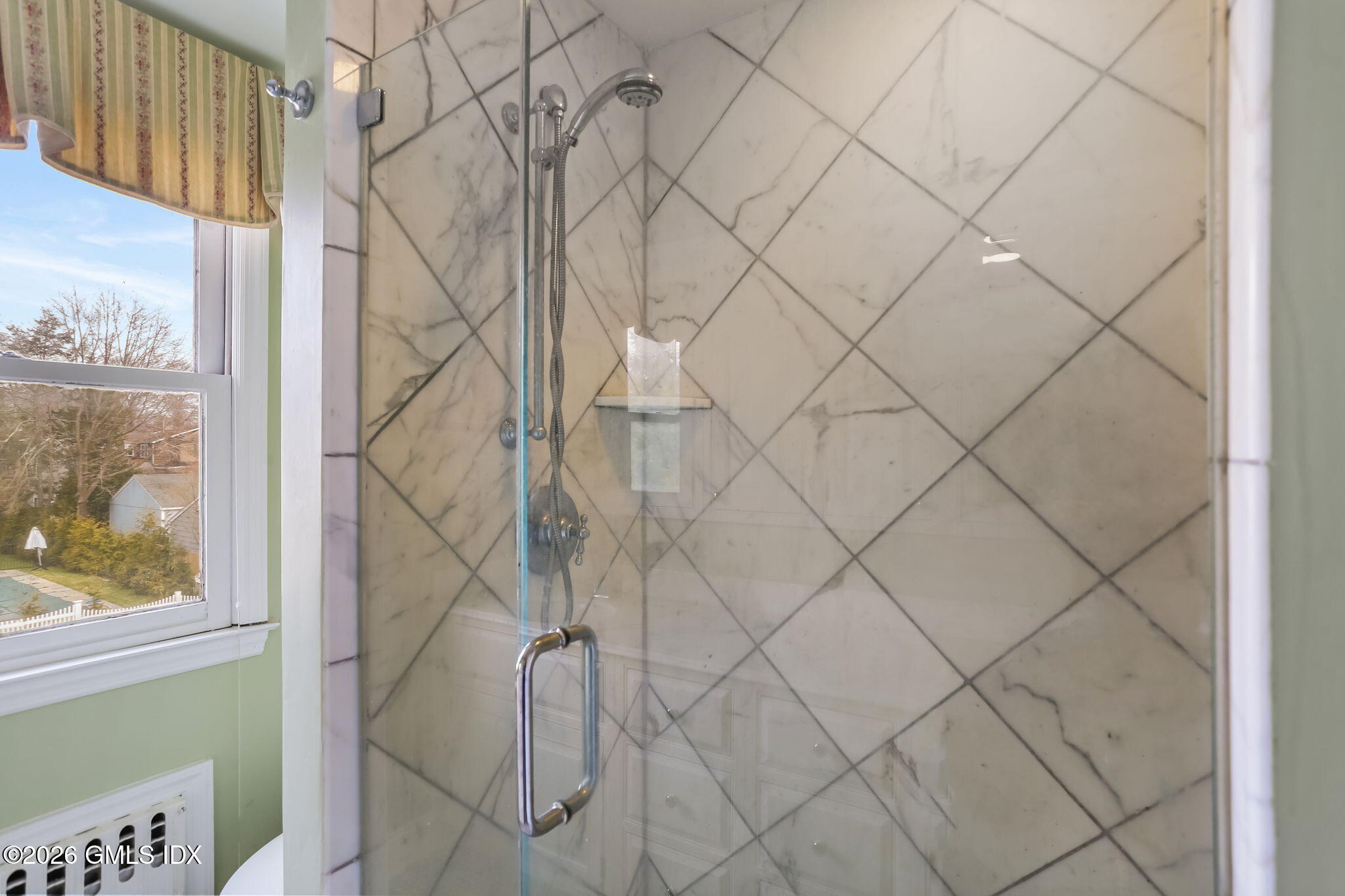 153 Lockwood Road Riverside, CT 06878 - Photo 32 of 58 a bathroom with a shower curtain and a window