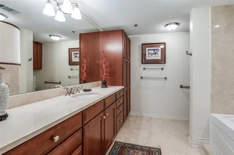 a bathroom with a shower sink and mirror