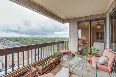 a bedroom with a bed chandelier and a window