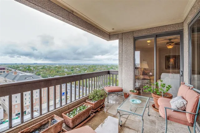 a bedroom with a bed chandelier and a window
