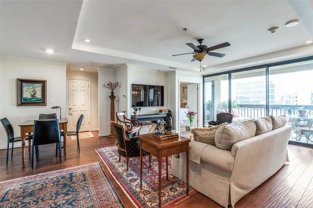 a living room with furniture a flat screen tv and a large window