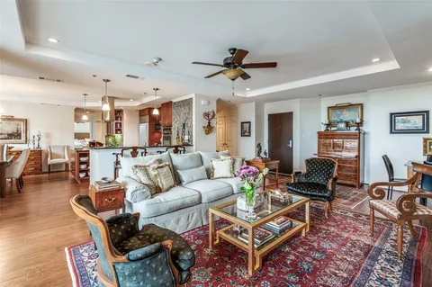a living room with furniture a ceiling fan and a rug