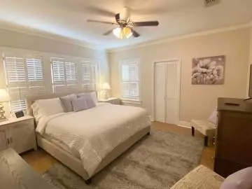 a bedroom with a bed and a chandelier