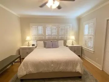 a spacious bedroom with a bed and window