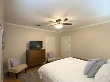 a bedroom with a bed and a television