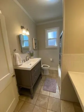 a bathroom with a sink mirror and a bathtub