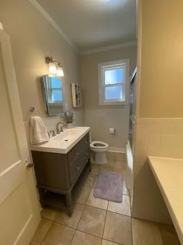 a bathroom with a sink mirror and a bathtub