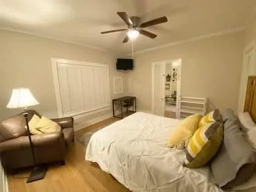 a bedroom with a bed couch and window