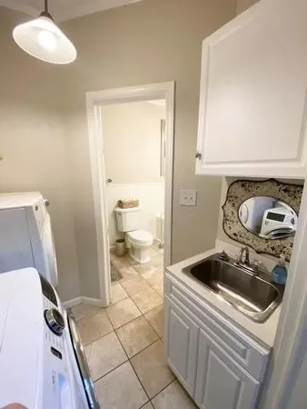 a bathroom with a sink and a washer dryer