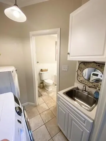 a bathroom with a sink and a washer dryer