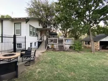 a view of a house with a yard porch and sitting area
