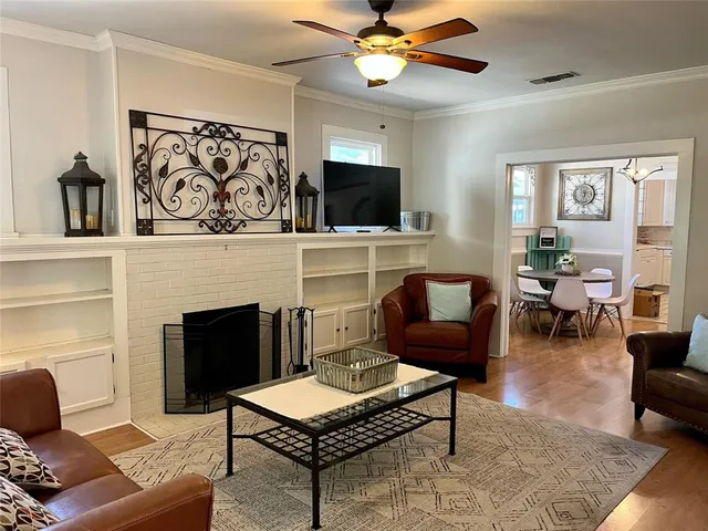 a living room with furniture and a fireplace
