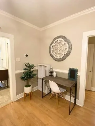 a view of a room with a table and chairs
