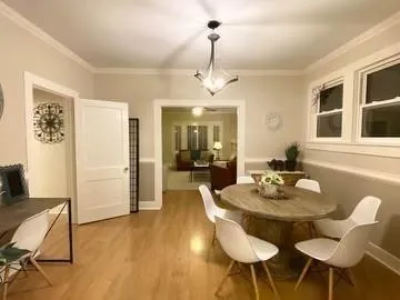 a view of a dining room with furniture and wooden floor