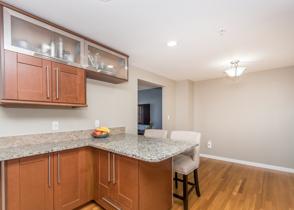 985 Trapelo Road, Unit 23 Waltham, MA 02452 - Photo 10 of 27 a kitchen with stainless steel appliances granite countertop a sink and cabinets