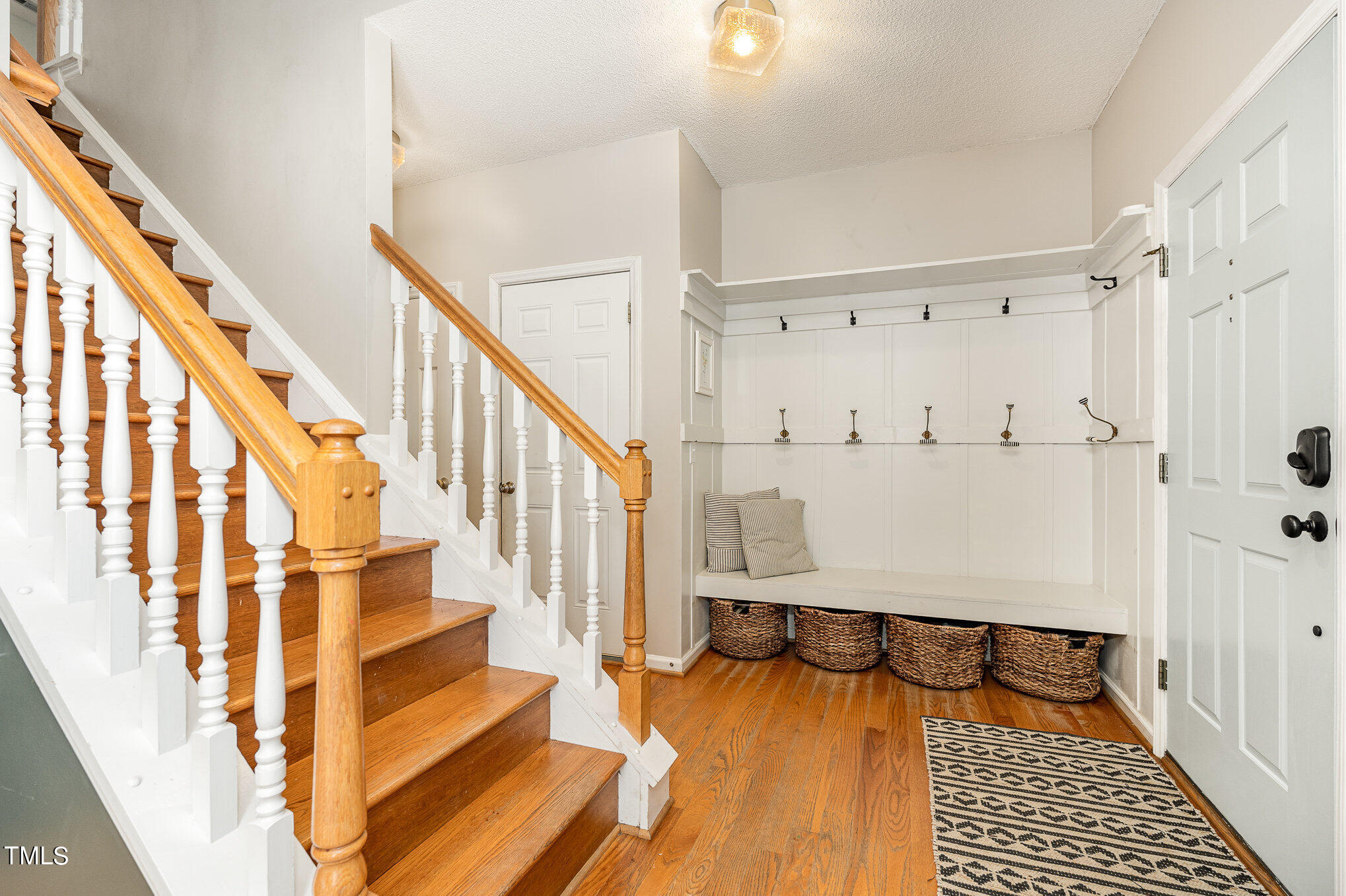 8516 Metronome Lane Raleigh, NC 27613 - Photo 14 of 25 a view of entryway with wooden floor and stairs