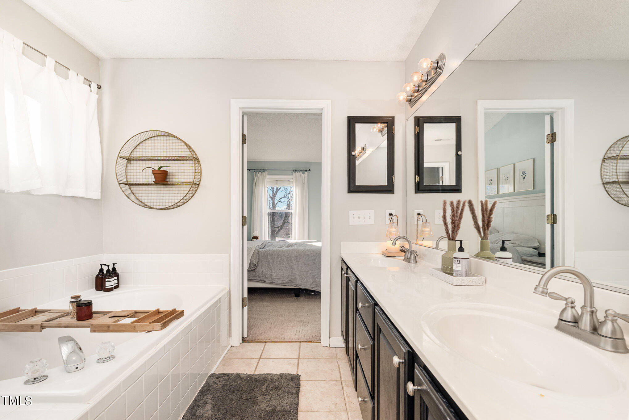 8516 Metronome Lane Raleigh, NC 27613 - Photo 17 of 25 a bathroom with a tub sink and mirror