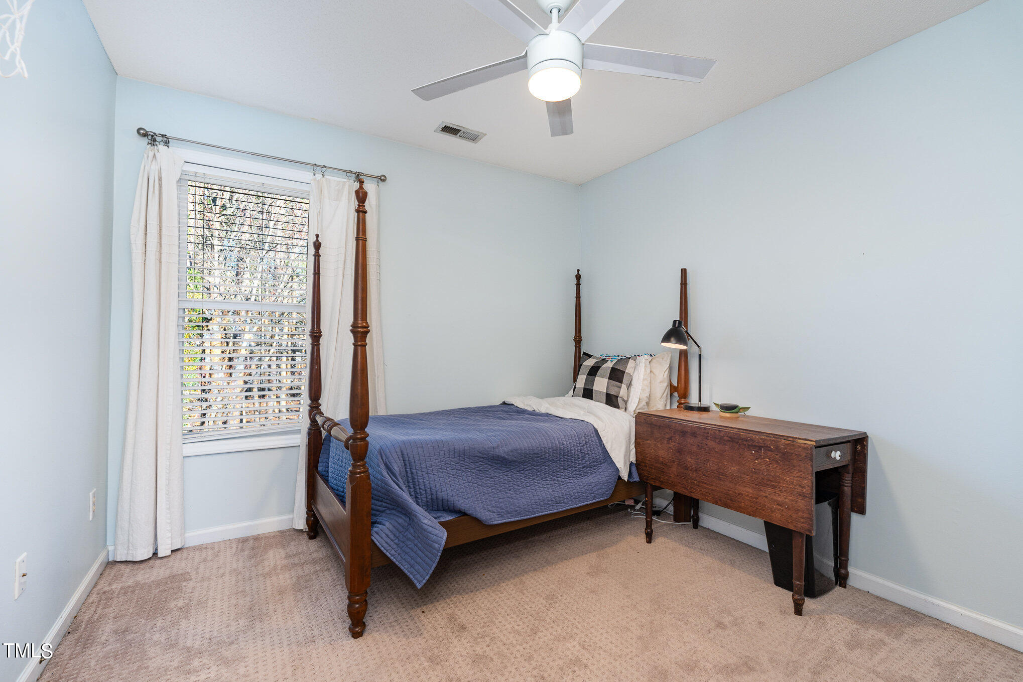 8516 Metronome Lane Raleigh, NC 27613 - Photo 21 of 25 a bedroom with a bed and a window