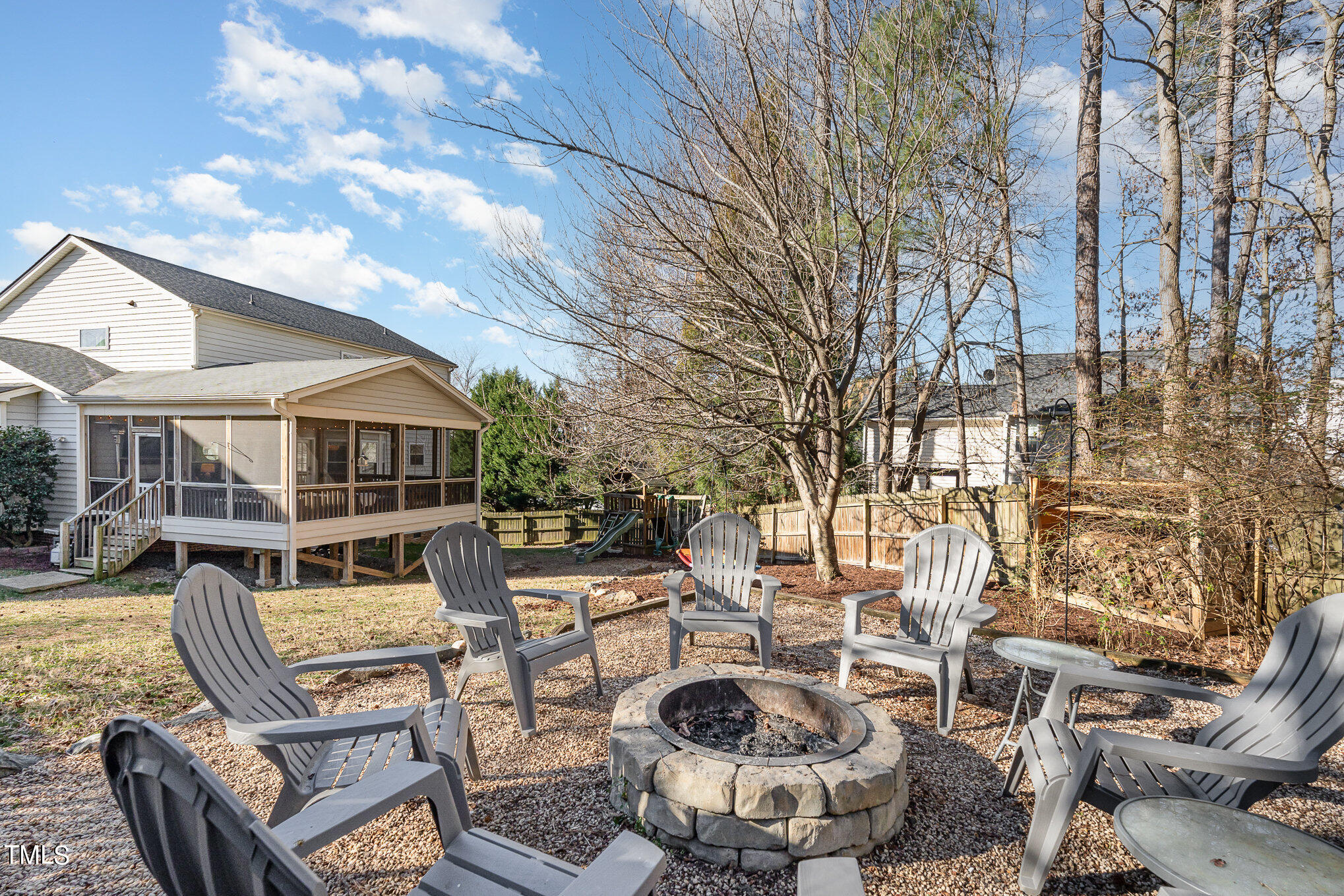 8516 Metronome Lane Raleigh, NC 27613 - Photo 24 of 25 a view of a patio with couches and table and chairs with wooden fence and plants