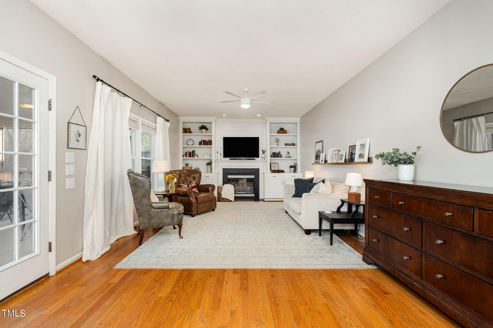 8516 Metronome Lane Raleigh, NC 27613 - Photo 7 of 25 a living room with furniture and a flat screen tv