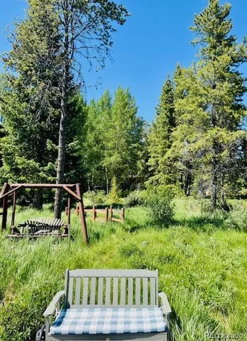 a view of backyard with deck and garden