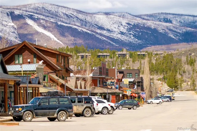 a view of a patio with lawn chairs under an umbrella