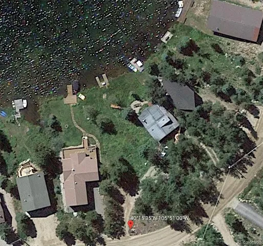 an aerial view of a house with a yard and trees