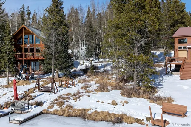 a view of a patio with table and chairs under an umbrella