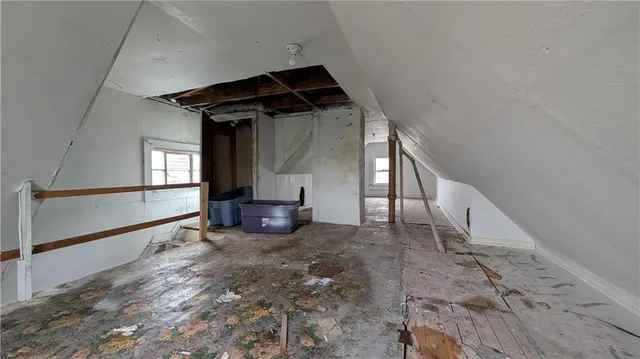 a view of a livingroom with wooden floor and a fireplace