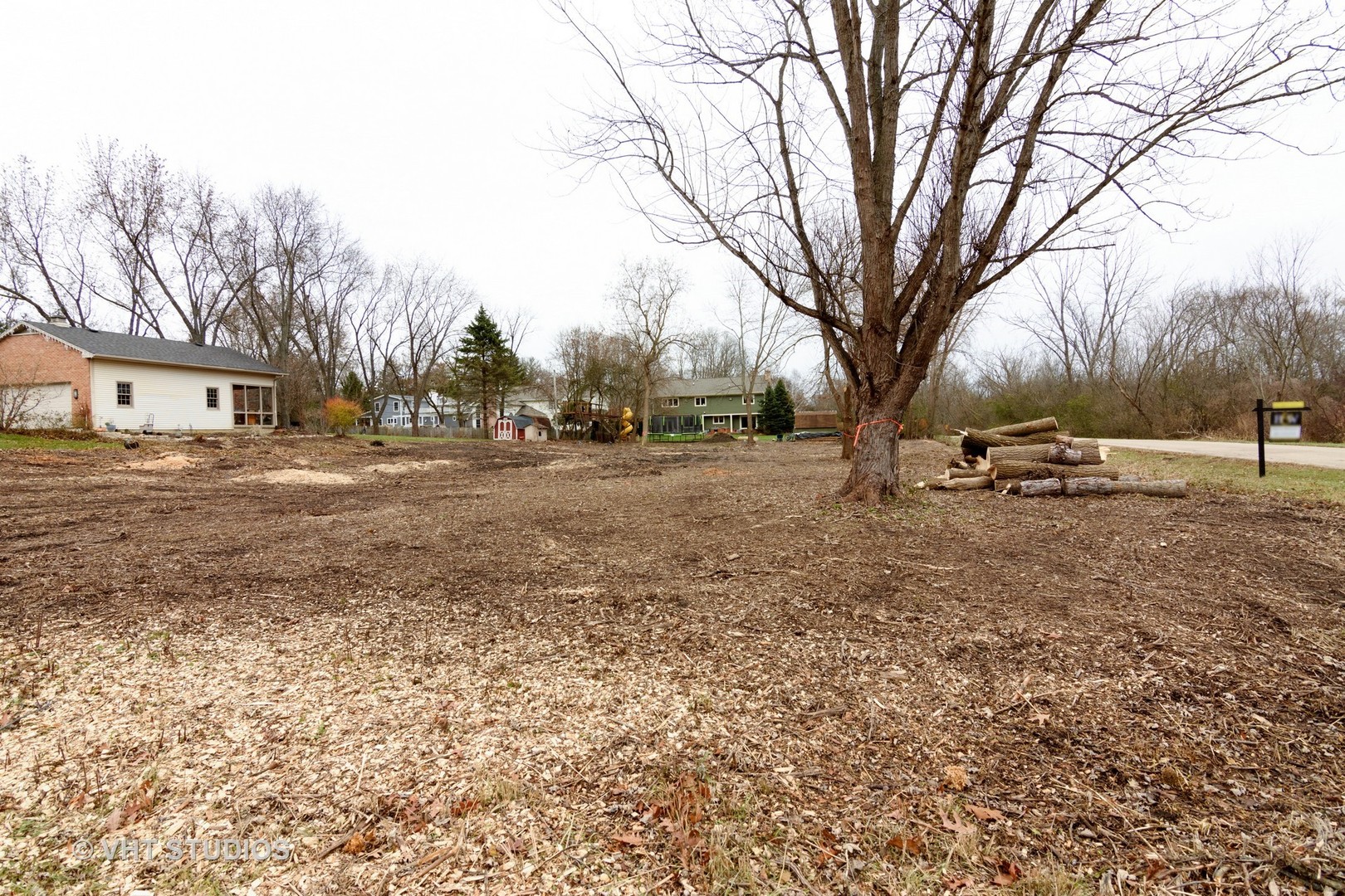 a view of dirt yard with a house