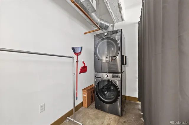 a bathroom with a granite countertop sink a toilet a mirror and shower