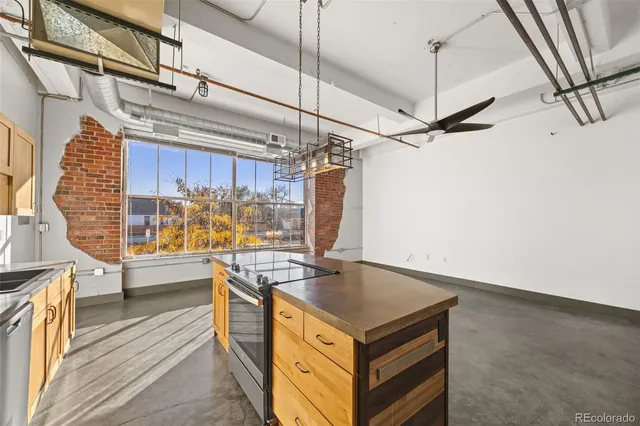 a view of a kitchen with furniture and wooden floor