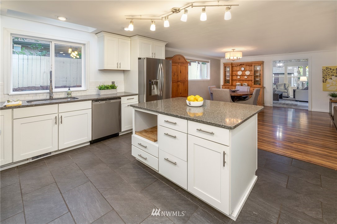 16945 Southeast 149th Street Renton, WA 98059 - Photo 11 of 40 a kitchen with white cabinets appliances and a center island