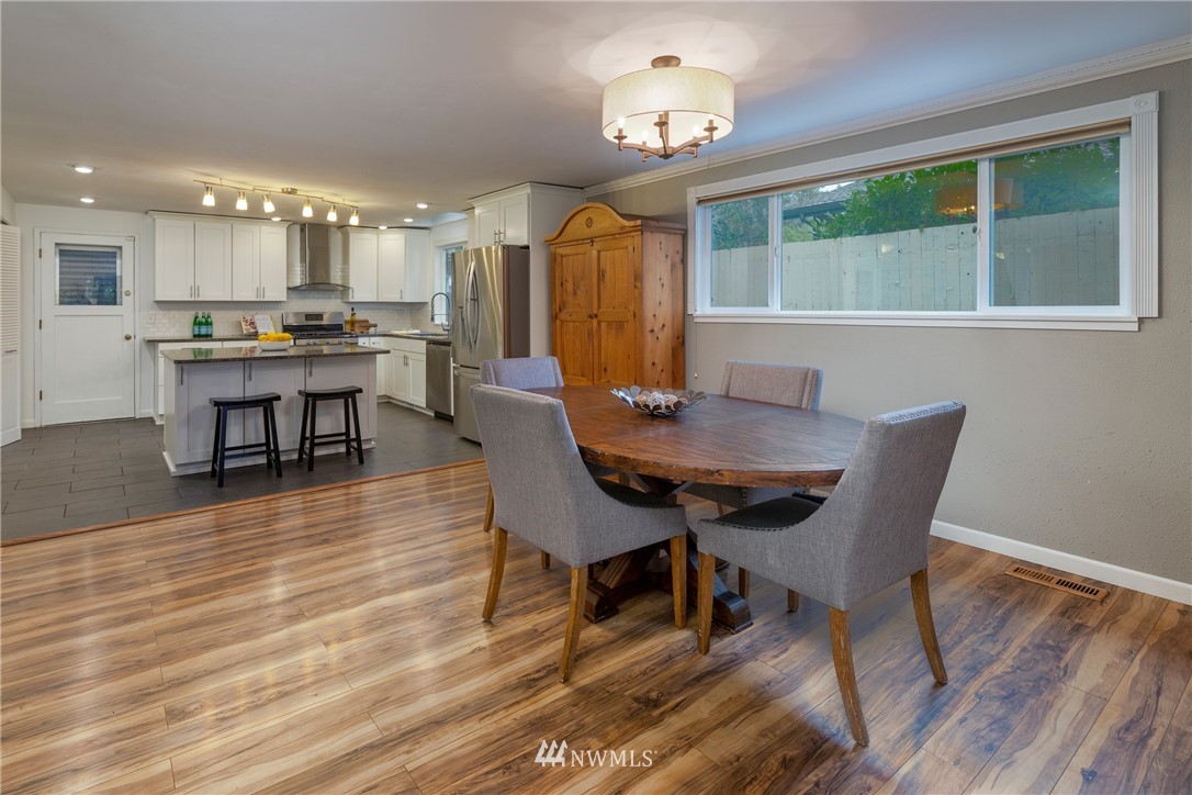 16945 Southeast 149th Street Renton, WA 98059 - Photo 14 of 40 a view of a dining room with furniture window and wooden floor