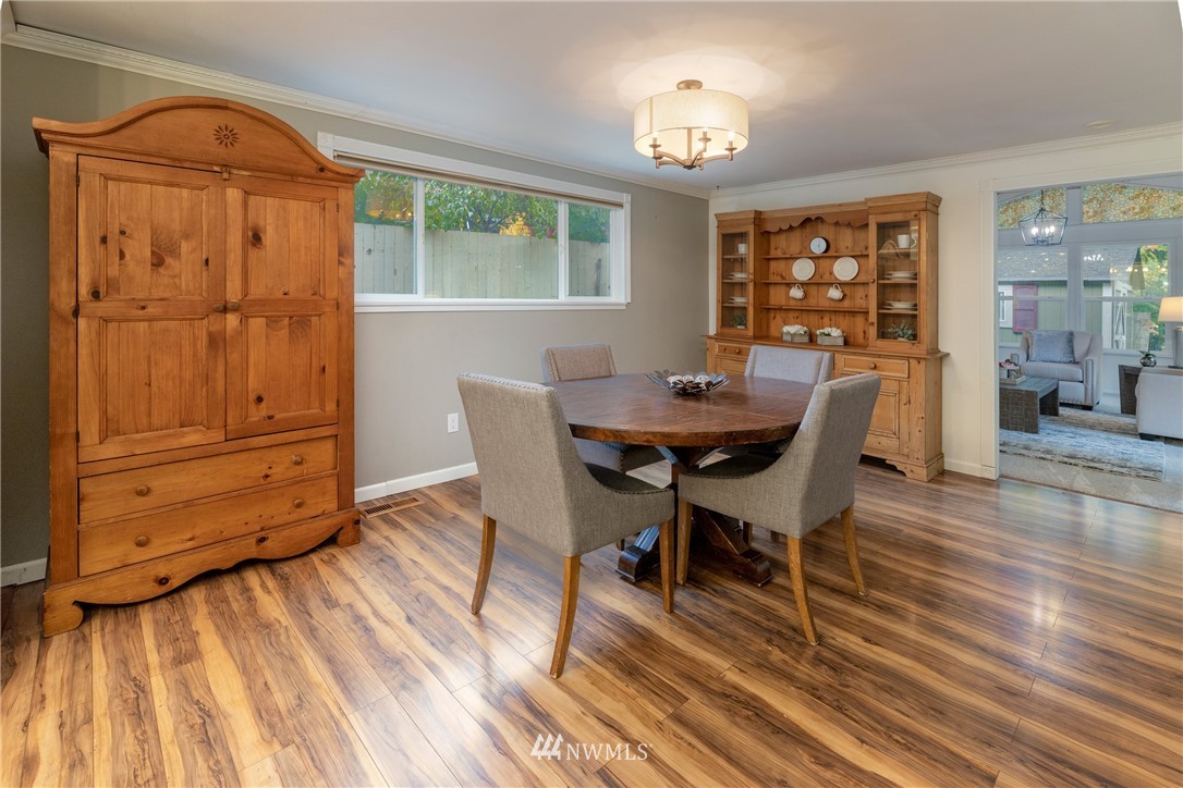 16945 Southeast 149th Street Renton, WA 98059 - Photo 15 of 40 a view of a dining room with furniture window and wooden floor