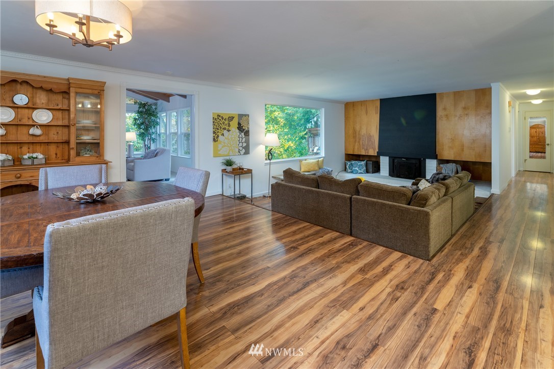 16945 Southeast 149th Street Renton, WA 98059 - Photo 22 of 40 a living room with furniture a lamp wooden floor and a large window