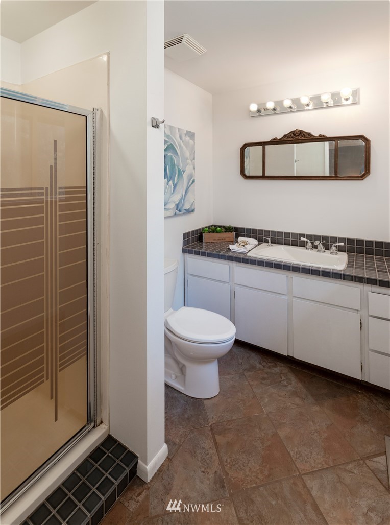 16945 Southeast 149th Street Renton, WA 98059 - Photo 26 of 40 a bathroom with a toilet a sink and mirror