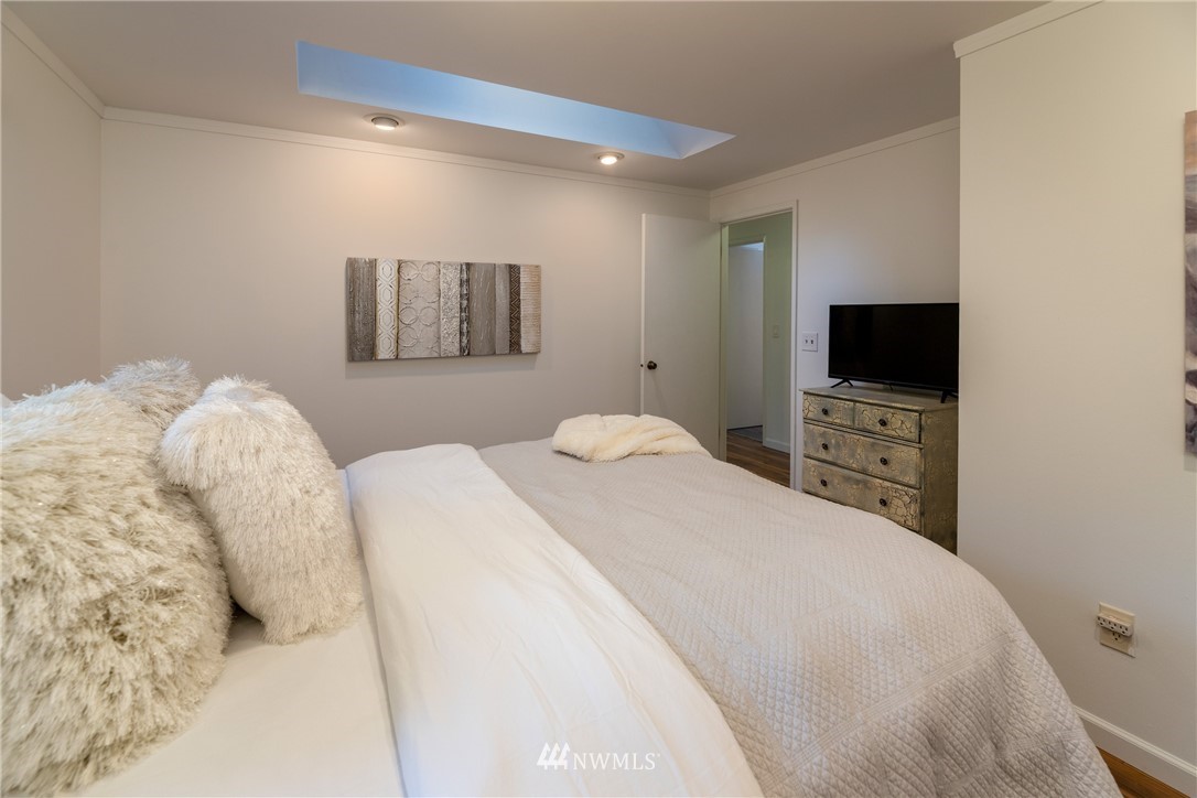 16945 Southeast 149th Street Renton, WA 98059 - Photo 28 of 40 a bedroom with a bed and a flat screen tv