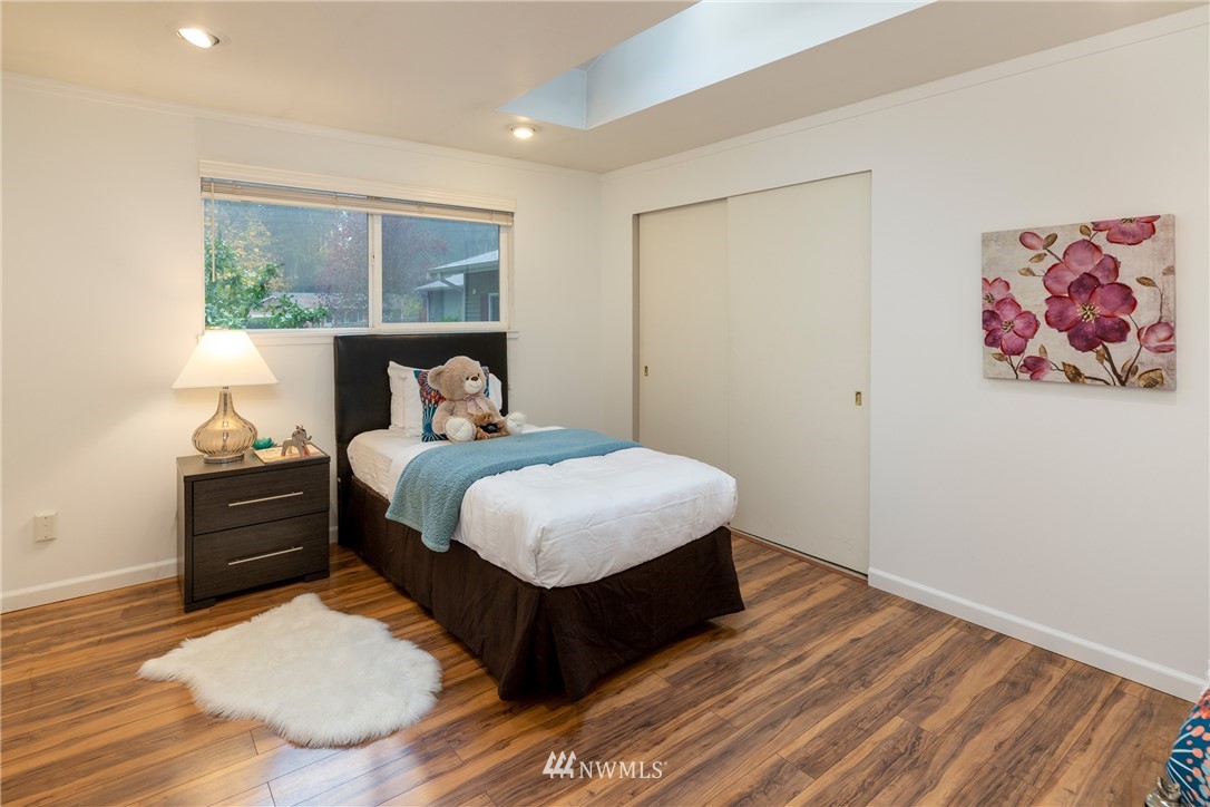 16945 Southeast 149th Street Renton, WA 98059 - Photo 32 of 40 a bedroom with a bed and wooden floor
