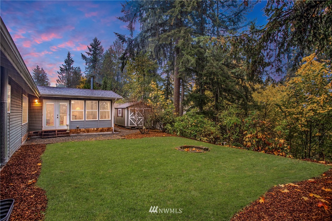 16945 Southeast 149th Street Renton, WA 98059 - Photo 37 of 40 a backyard of a house with a large tree and wooden fence